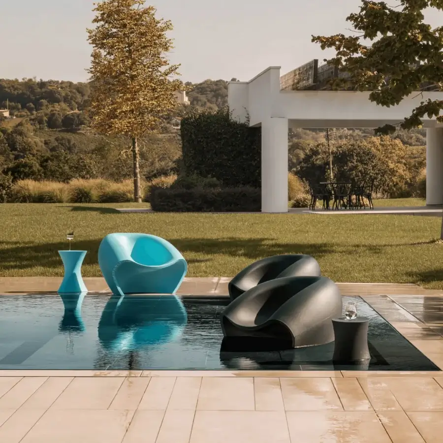 Distinctive MY YOUR Iris Lounge chair crafted in recyclable Poleasy with a turquoise blue hue and smooth matte finish