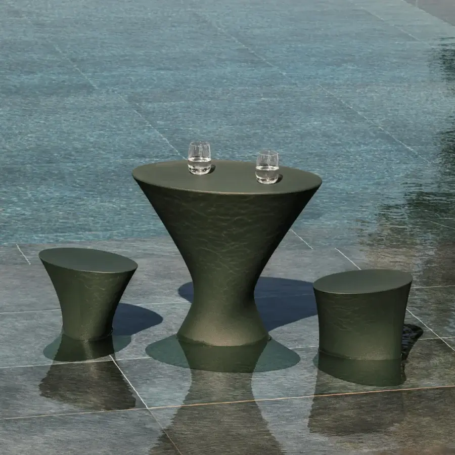 Distinctive MY YOUR Iris table crafted from recyclable Poleasy with a dark teal finish and hourglass silhouette