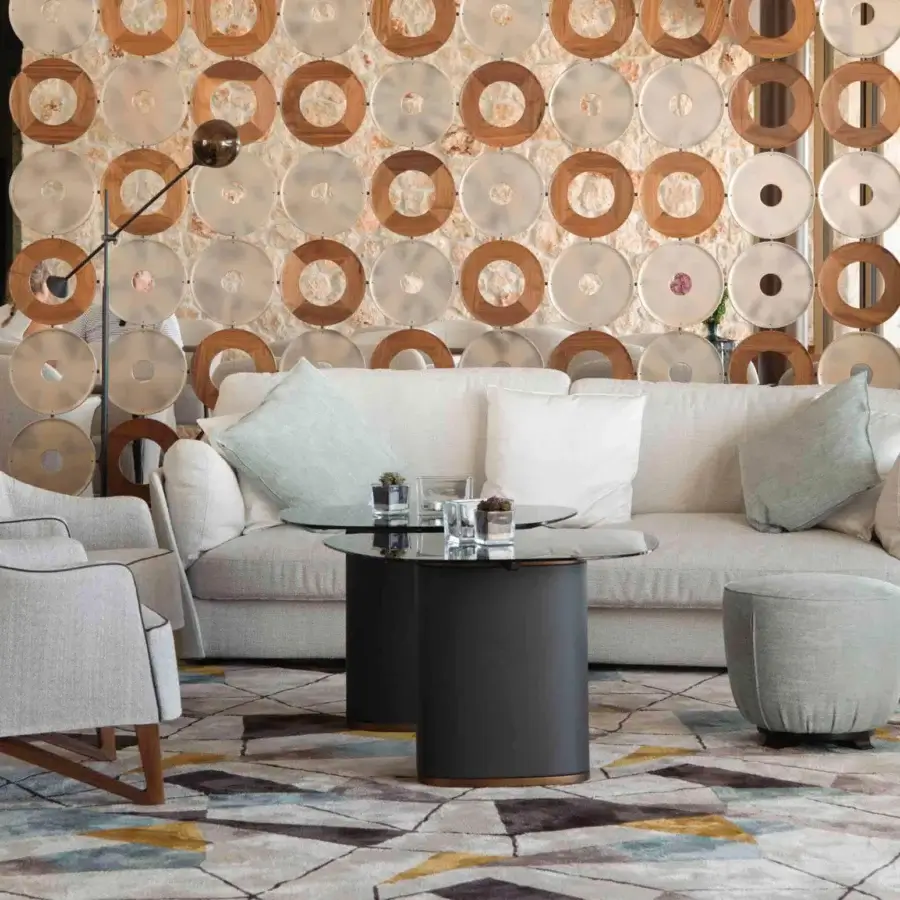 Distinguished Giorgetti Topaze ottoman built with plush polyester fibers and light neutral textile upholstery with polished beech base