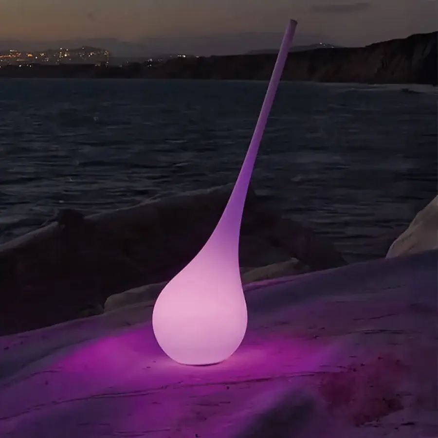 Distinguished MY YOUR Ampoule XL floor lamp sculpted in recyclable Poleasy® with satin finish casts a soft purple glow
