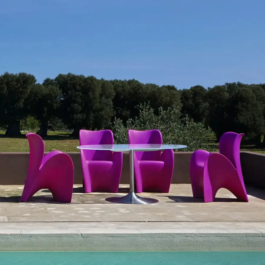 Captivating MY YOUR Lily chair embodies sculpted form with magenta synthetic material and glossy finish