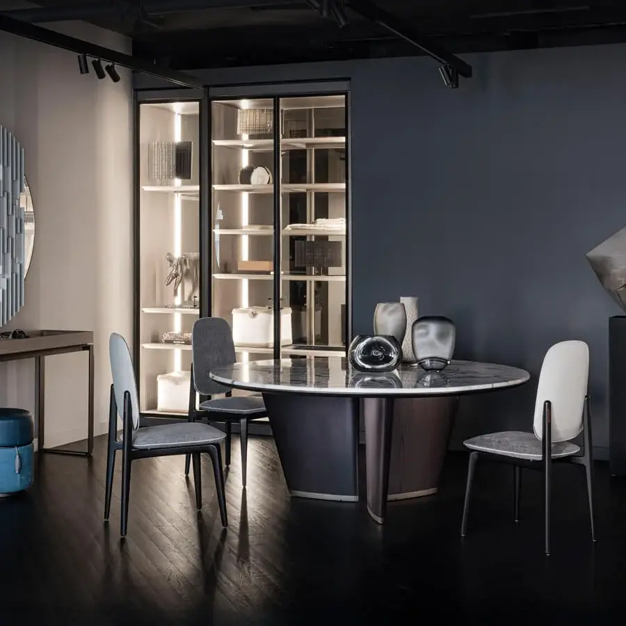 Superior Giorgetti Mistral round table with a marble top, bronze insert, and veneered ash wood legs with a lacquered titanium plinth
