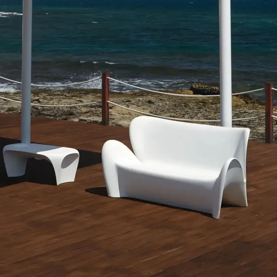 Distinguished MY YOUR Lily sofa with organic curves molded from smooth glossy synthetic material offering a uniquely modern lounging experience