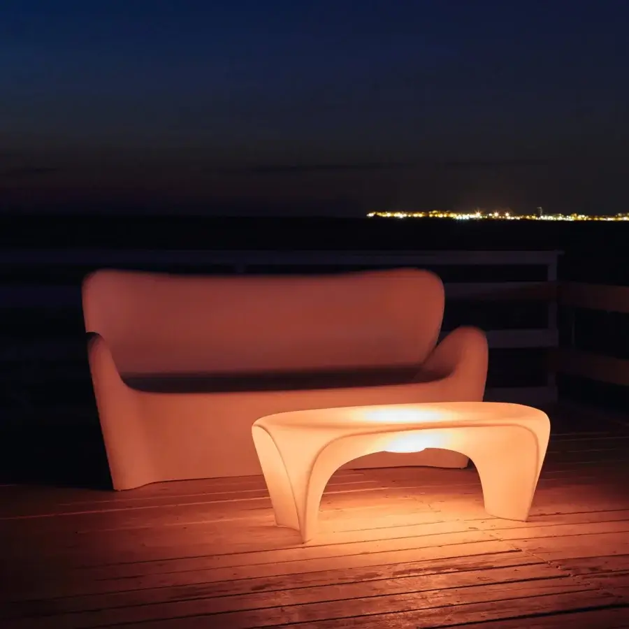 Superior MY YOUR Lily sofa with satin finish and warm orange translucent synthetic material molded into curved form
