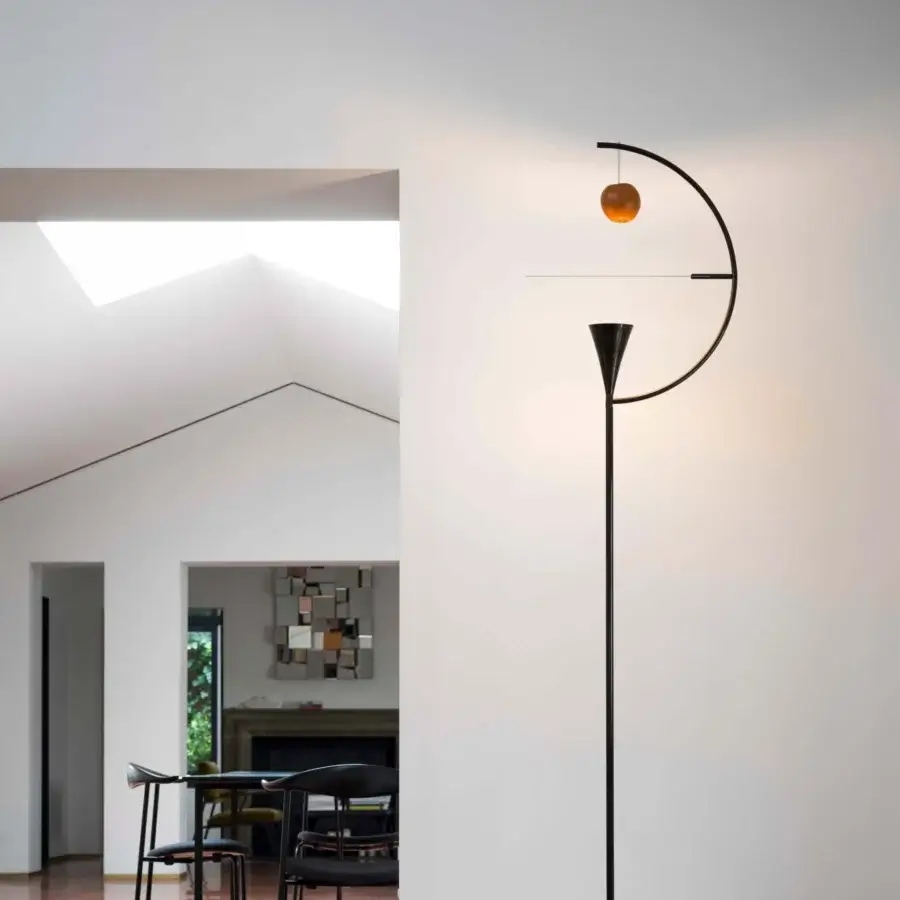 Superior Nemo Newton floor lamp crafted in matte black metal with rotating diffuser and warm amber sphere