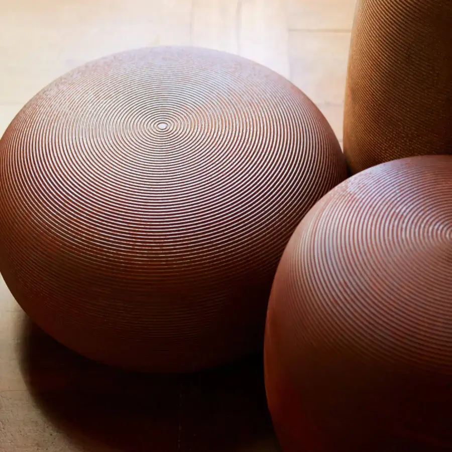 Distinguished MY YOUR Pandora stool with organically rounded form and reddish-brown molded material featuring a textured ridged surface