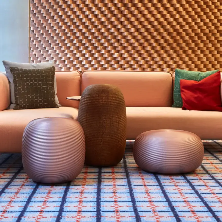Captivating MY YOUR Pandora stool with organic rounded form crafted in textured synthetic material with a muted terracotta tone and matte finish