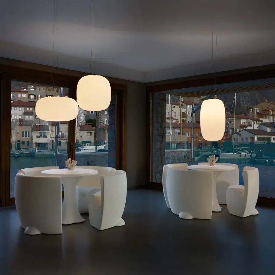 Distinctive MY YOUR Rhonda chair with captivating organic form molded in bright white matte plastic for outdoor use