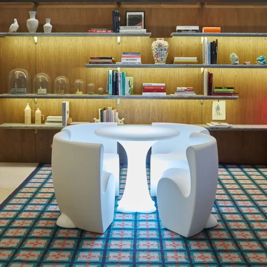 Elegant MY YOUR Rhonda chair with unique organic form sculpted in glossy white synthetic material for outdoor use
