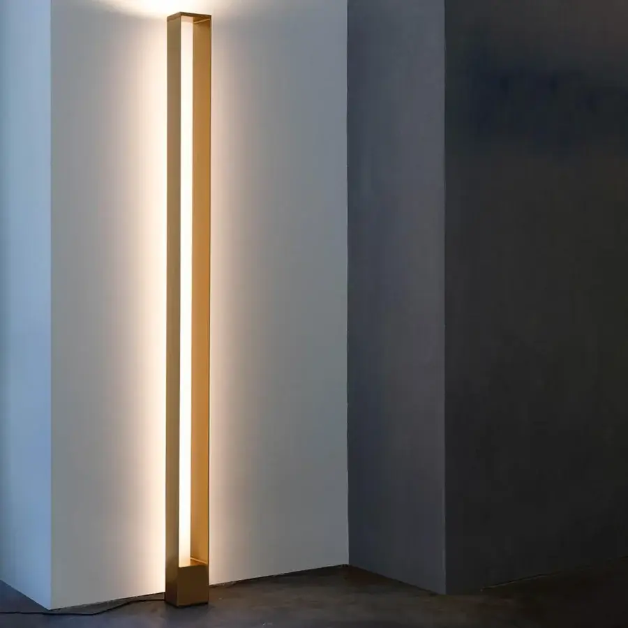 Distinguished Nemo Tru floor lamp with sculptural minimalist design crafted in aluminum and polycarbonate with muted gold finish