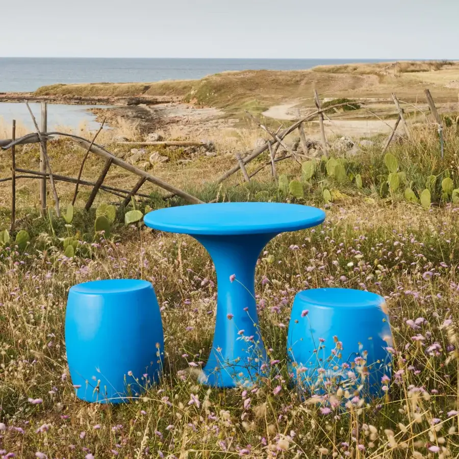 Exceptional MY YOUR Teddy table crafted in saturated blue plastic with a glossy finish and matching stools