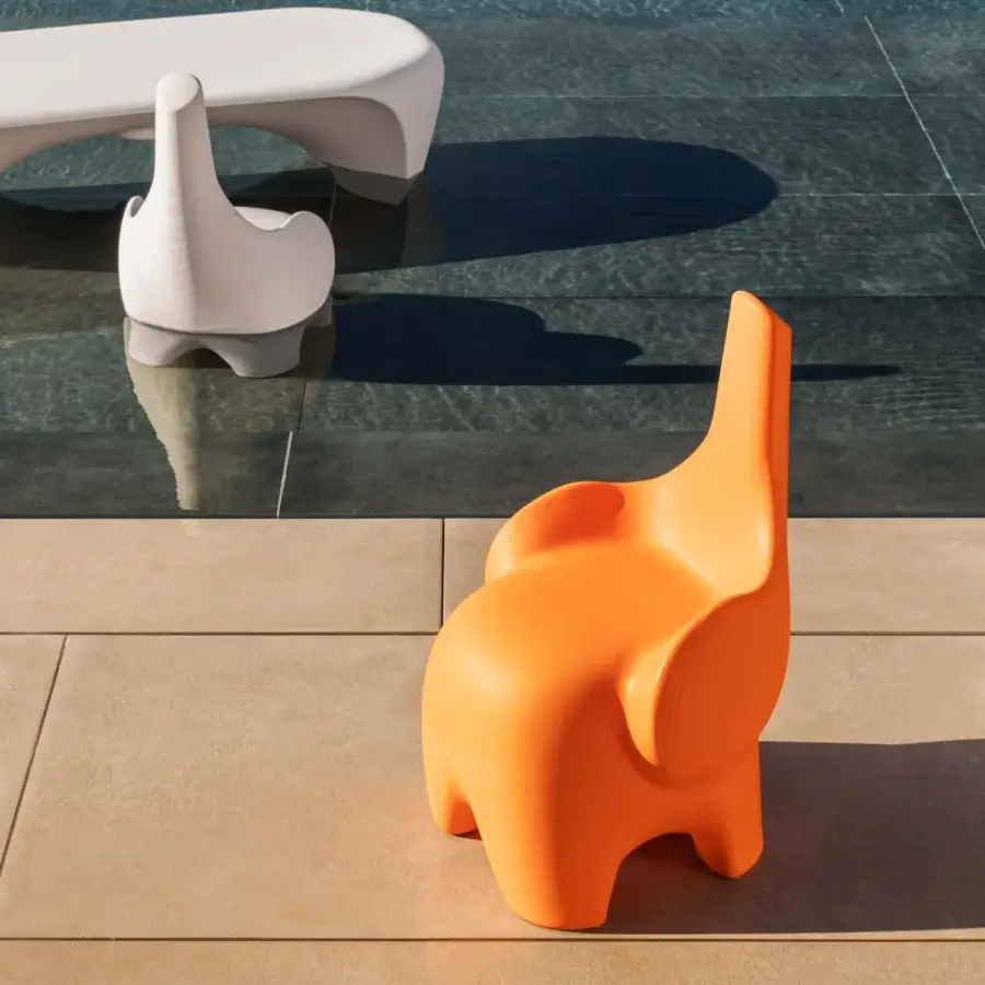 Exceptional MY YOUR Tino chair sculpted from durable Poleasy plastic with a smooth orange finish evoking animalistic form