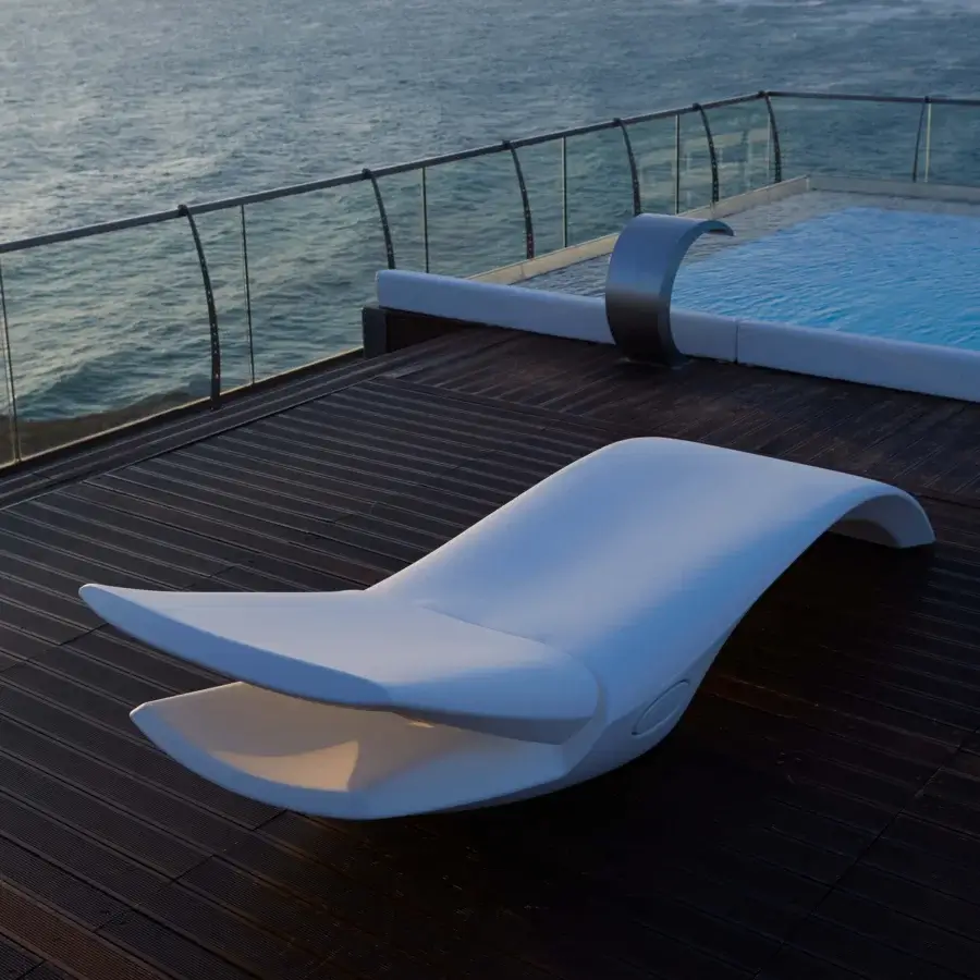 Distinguished MY YOUR Zoe Lounger, a contemporary lounger built in matte white Poleasy® plastic with a curved brushed metal back support