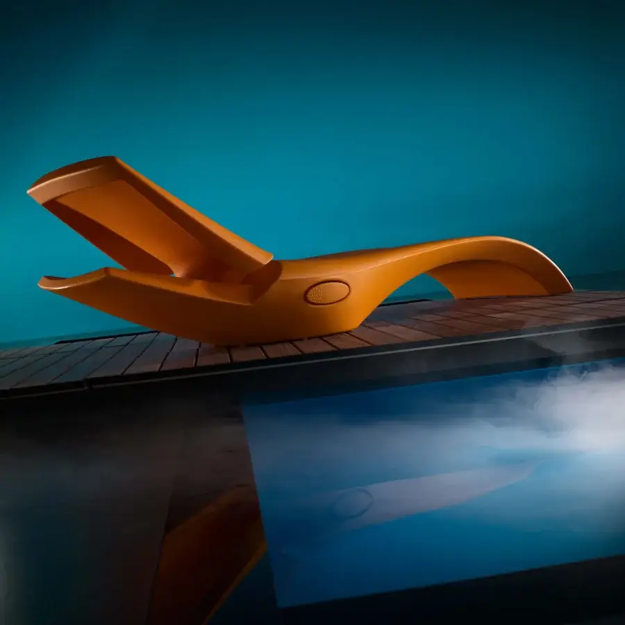 Superior MY YOUR Zoe Lounger, a contemporary lounger crafted in warm orange Poleasy® plastic with fully chromed metal devices and a matte finish