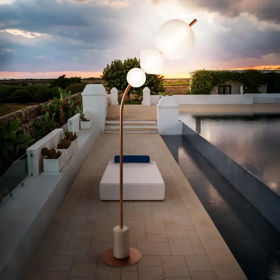 Captivating Lanzavecchia-Wai Joy floor lamp built with a marble base, curved copper-finish metal, and bright white Poleasy lampshades