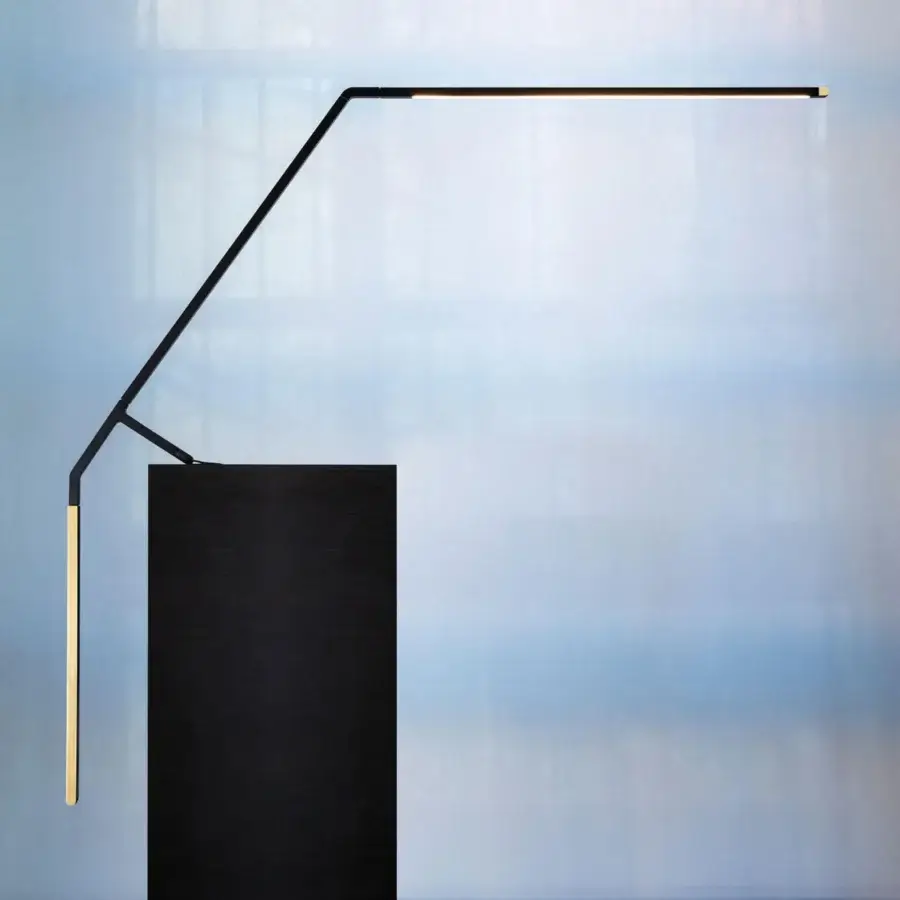 Distinguished Nemo Bird table lamp crafted in Italy with matte black metal and satin gold counterweight offering balanced illumination