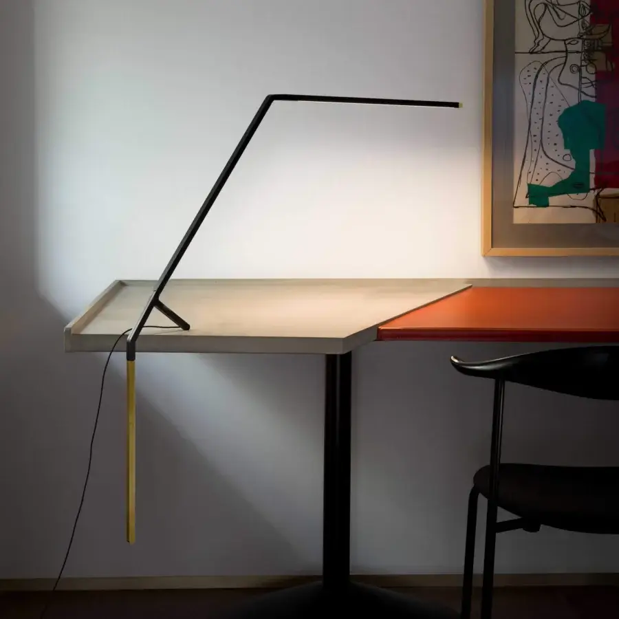 Superior Nemo Bird table lamp in matte black metal with a weighted gold-toned brass counterweight crafted in Italy