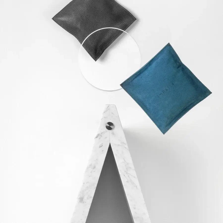 Distinctive Impatia Lancio cornhole with a solid marble base and sleek glass playing surface crafted in dark gray Alcantara® and teal leather bags