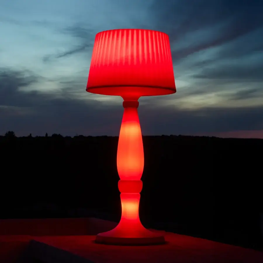 Distinguished MY YOUR Agata floor lamp with a curved silhouette, glossy red plastic construction and flared pleated lampshade