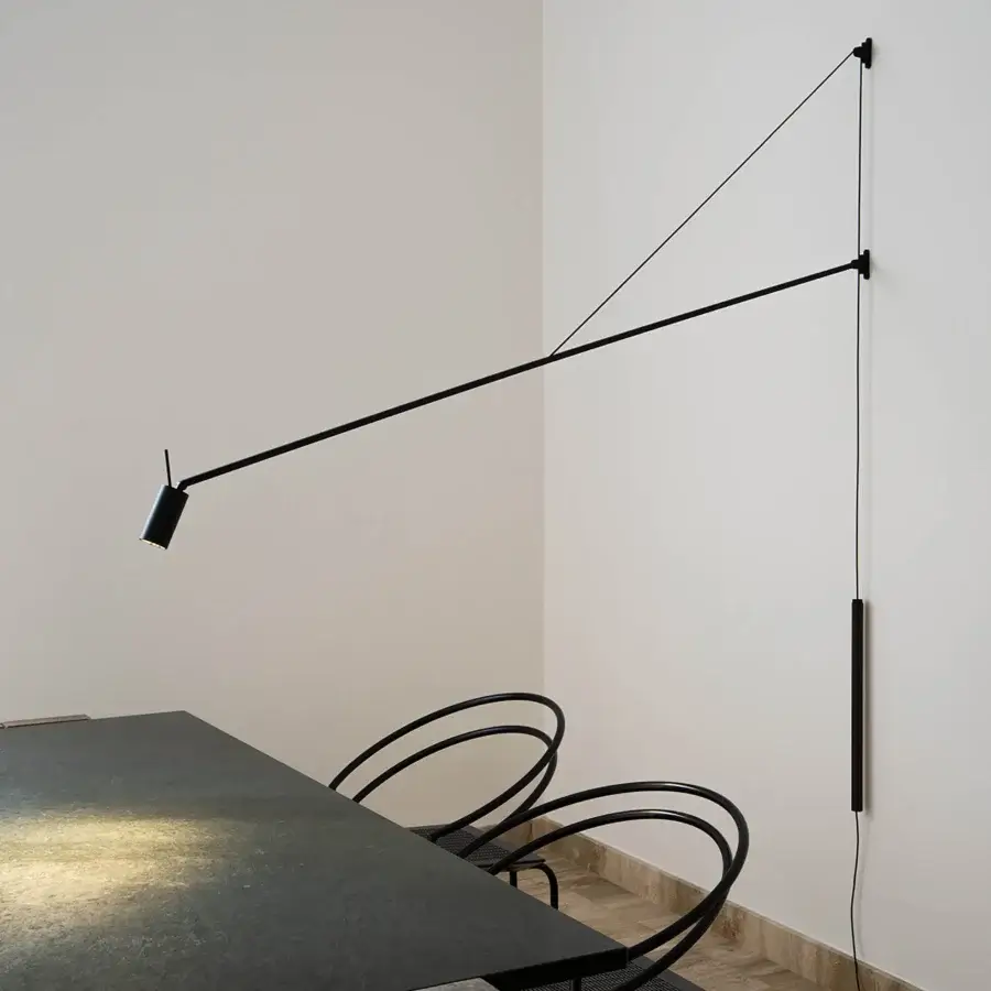Elegant Nemo Lighting Swan wall lamp crafted in matte black metal with a refined counterweight covered in Testa di Moro leather