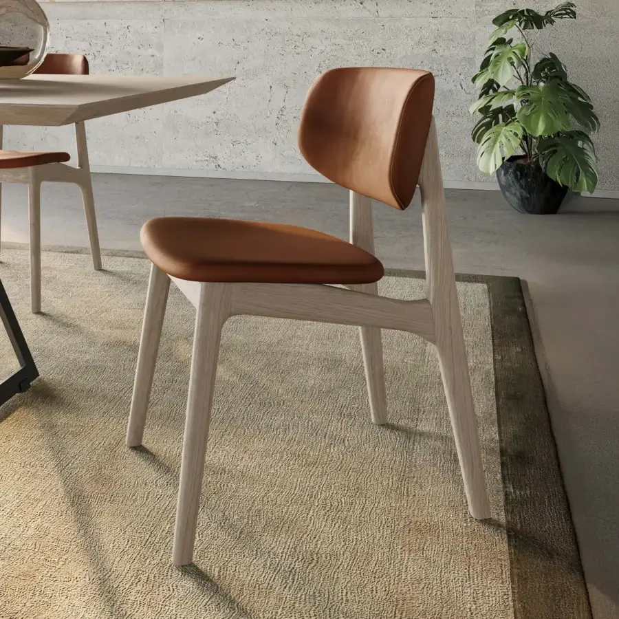 Distinguished Dallagnese Float chair with handcrafted solid ash frame and warm brown leather-like seat, finished with electrostatic coating