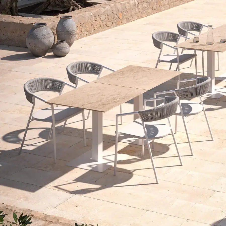 Distinguished MY YOUR Maja armchair with a curved silhouette crafted in neutral gray synthetic rope and textilene with a powder-coated aluminum frame
