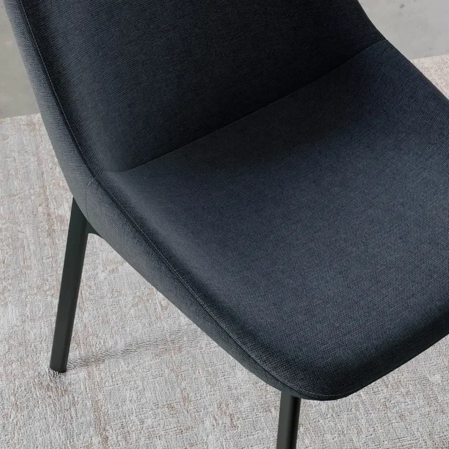 Exceptional Dallagnese Le Mans chair upholstered in dark gray quilted fabric with a TIG-welded metal frame and brass reinforcement