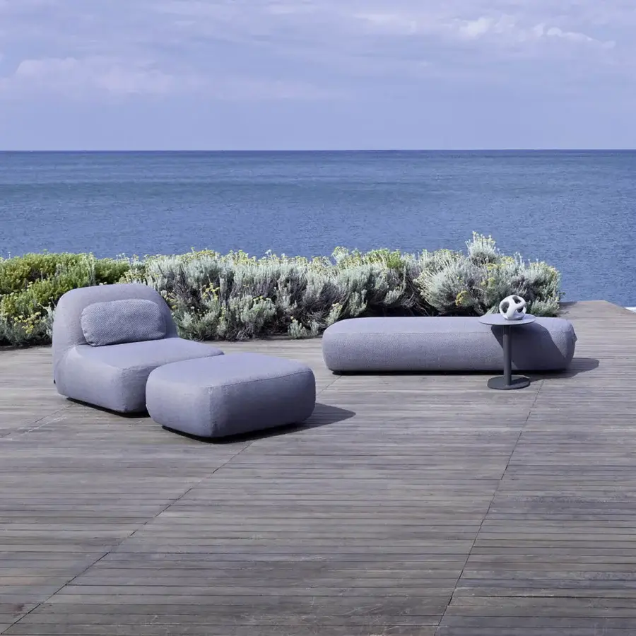 Elegant Varaschin Reuse outdoor sofa built with okumè wood and textured hemp fabric in a muted gray tone