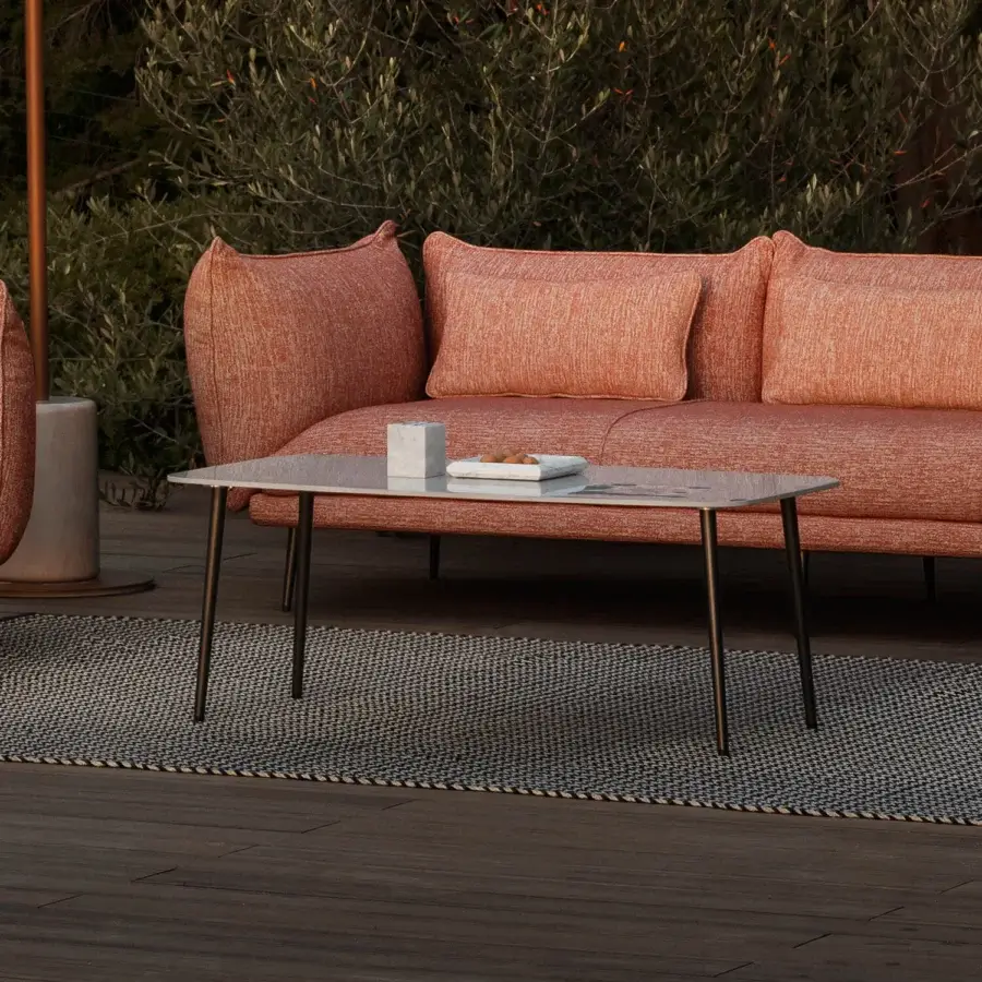 Distinguished MY YOUR Piuma coffee table with a muted grey stone tabletop and matte black aluminum base