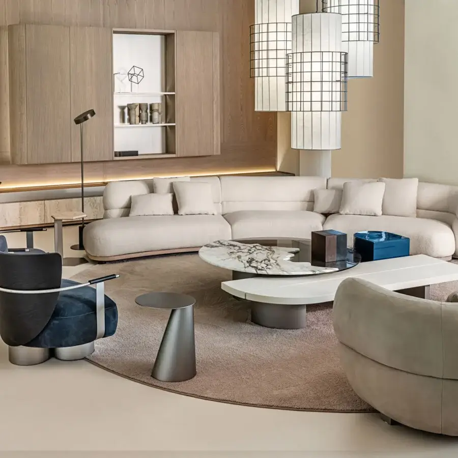 Superior Shake Vogue sofa with inviting curved form upholstered in smooth light beige textile and varnished steel feet