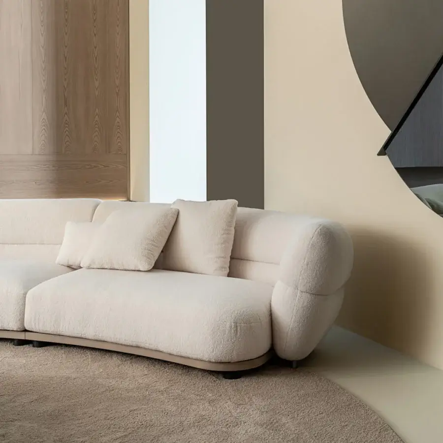 Lavish Shake Vogue sofa with organically curved silhouette upholstered in textured pale beige bouclé and matte finish