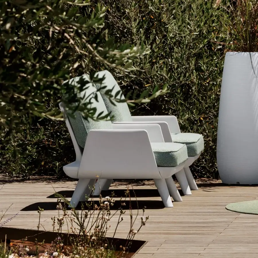 Exceptional MY YOUR Samurai lounge chair with a matte white frame and pale green textured textile upholstery