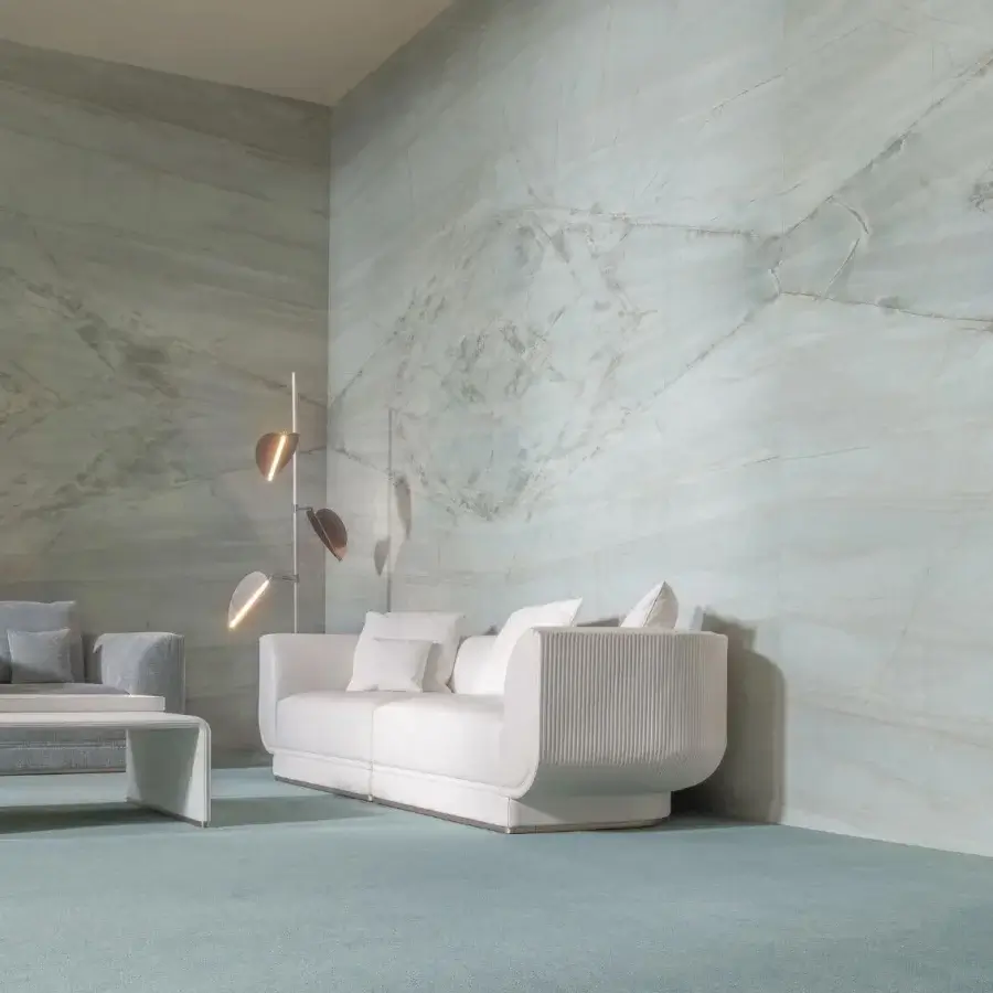 Exceptional Visionnaire Foster sofa with creamy white fabric upholstery and distinctive vertical canneté quilting crafted with a hidden metal plinth base