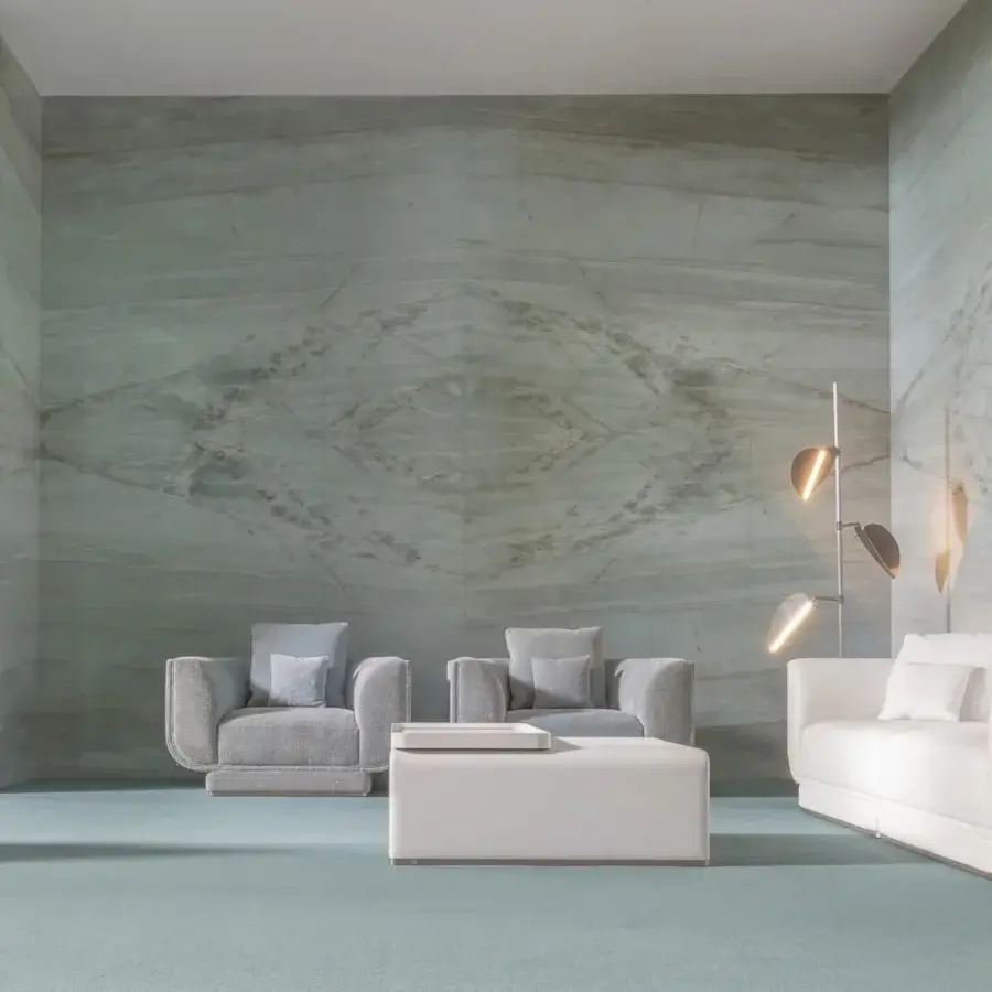 Lavish Visionnaire Foster sofa with light neutral textile upholstery and sleek metal-clad plinth base exhibiting canneté quilting
