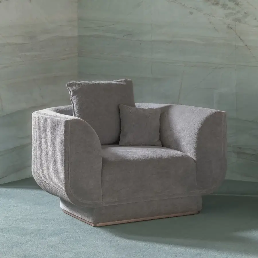 Distinguished Visionnaire Foster lounge chair with textured fabric upholstery, canneté stitching and a polished stainless steel plinth base