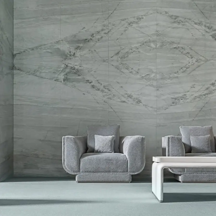 Exceptional Visionnaire Foster lounge chair with muted gray textile upholstery, canneté stitching and polished stainless steel base