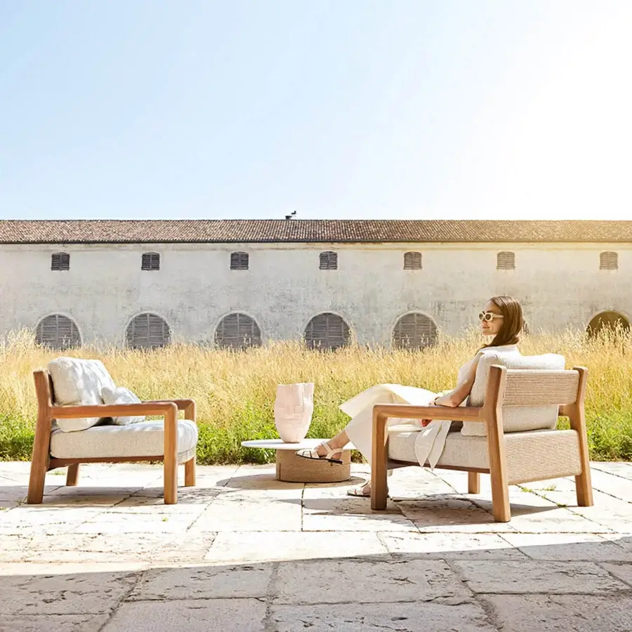 Distinguished Varaschin Gianna lounge chair with aluminum structure, Iroko wood sides, and soft beige cushion in Desert finish
