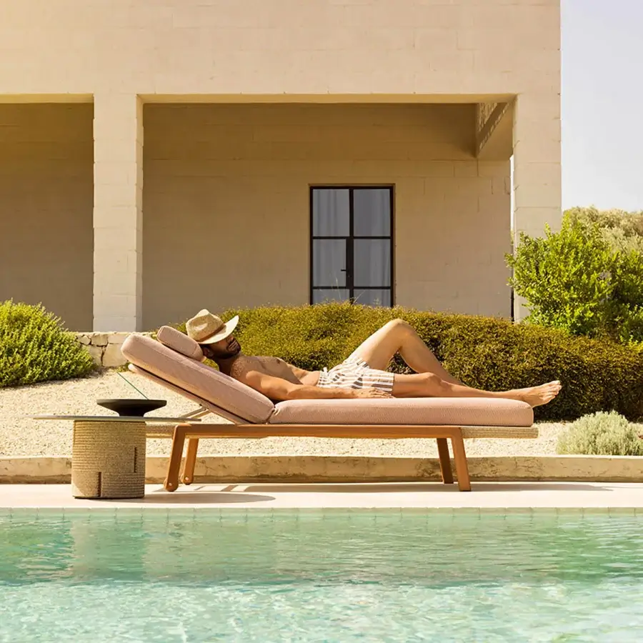 Distinguished Varaschin Gianna lounger with wheels in pale rose textile and Iroko wood accents with off-white cushioning