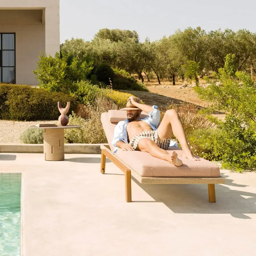 Refined Varaschin Gianna lounger with wheels in muted rose-beige textile and visible Iroko wood accents, built with a durable aluminum frame