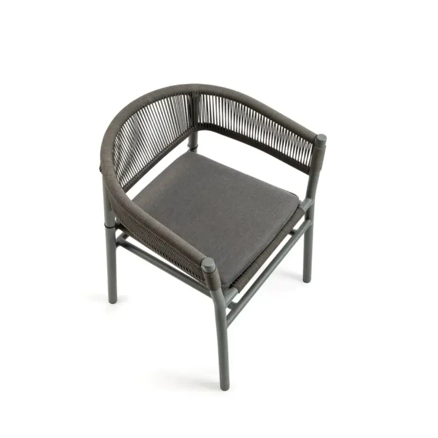 Luxury Ethimo Kilt armchair with a curved silhouette crafted in teak and woven natural fiber