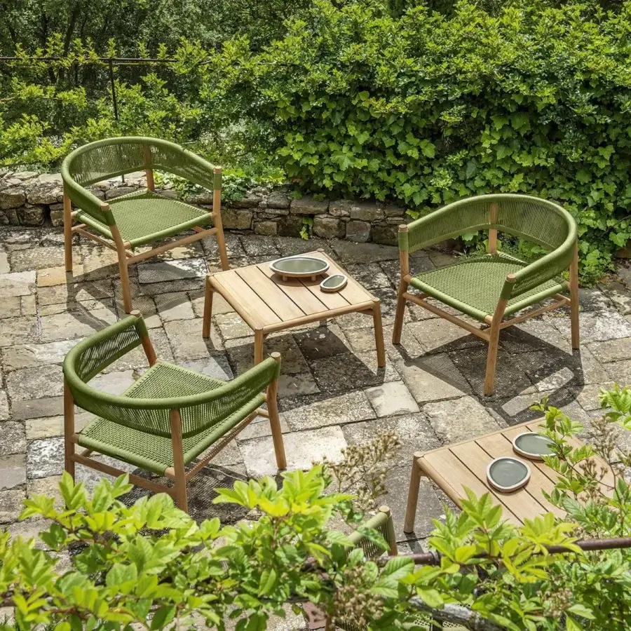 Harmonious Ethimo Kilt armchair crafted in FSC-certified teak with a soft natural fibre weave and muted green hue