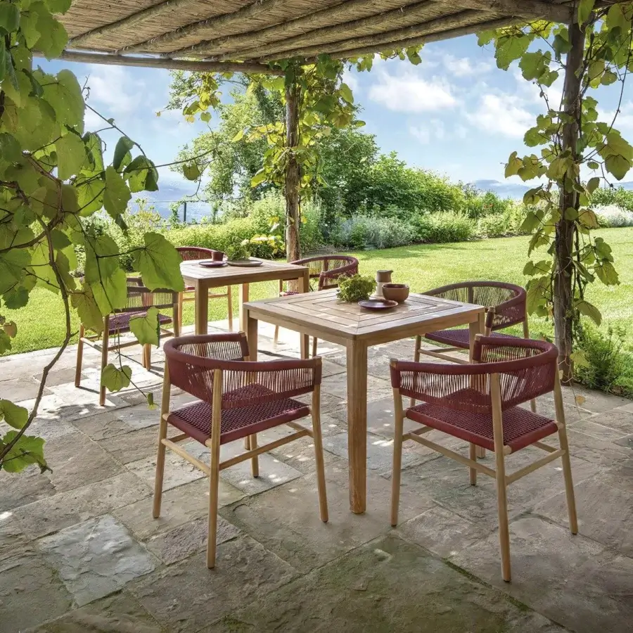 Harmonious Ethimo Kilt armchair crafted with FSC-certified teak and a natural fibre weave in a muted reddish-brown hue