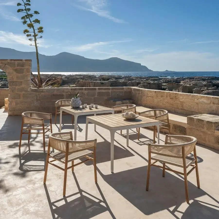 Elegant Ethimo Kilt armchair crafted with FSC-certified teak and light beige natural fibre weave for outdoor use