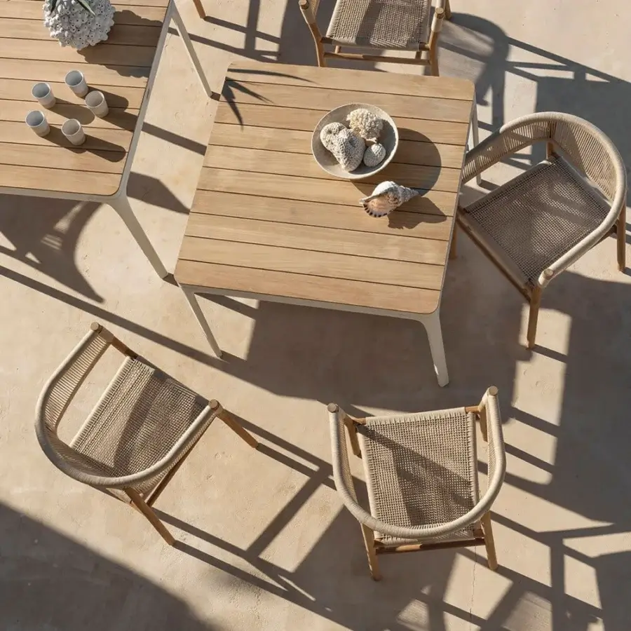 Harmonious Ethimo Kilt armchair crafted with FSC-certified teak and a natural fiber weave in a warm light brown hue