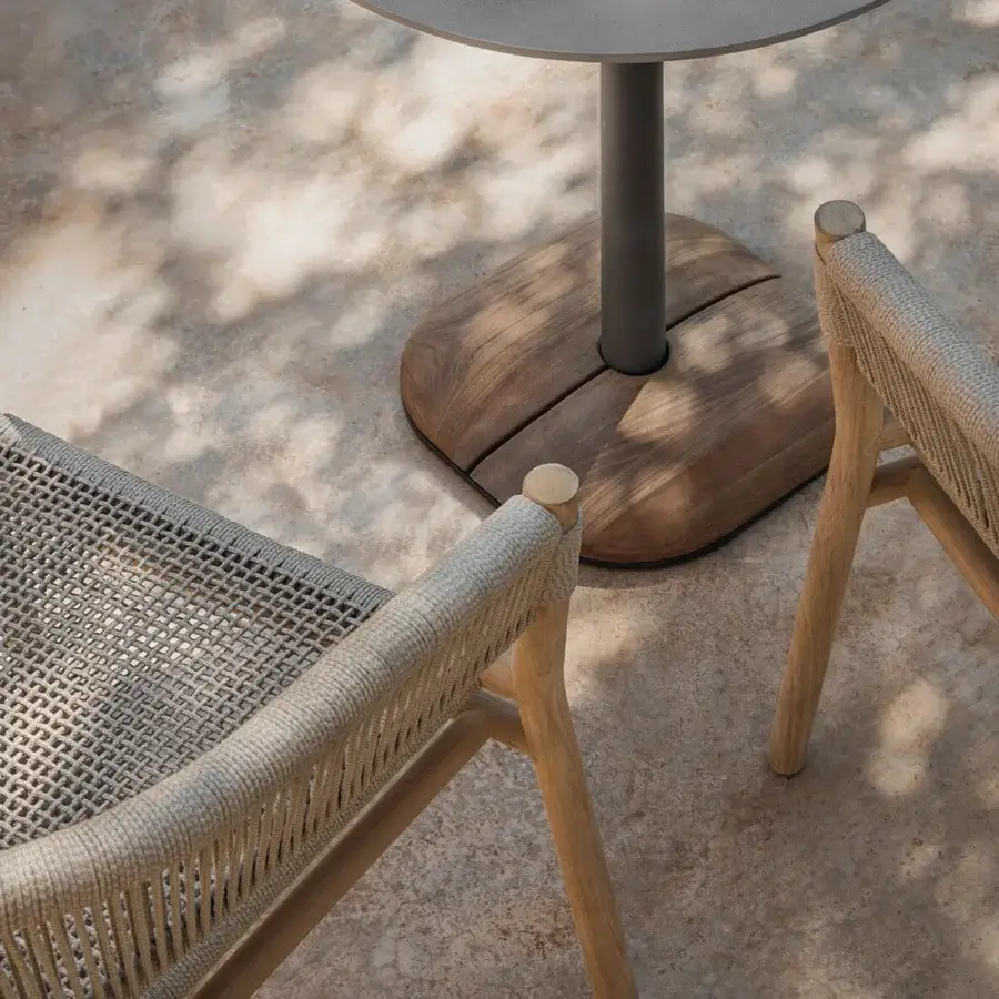 Distinguished Ethimo Kilt armchair crafted with FSC-certified teak and soft muted gray woven fiber for relaxed outdoor seating