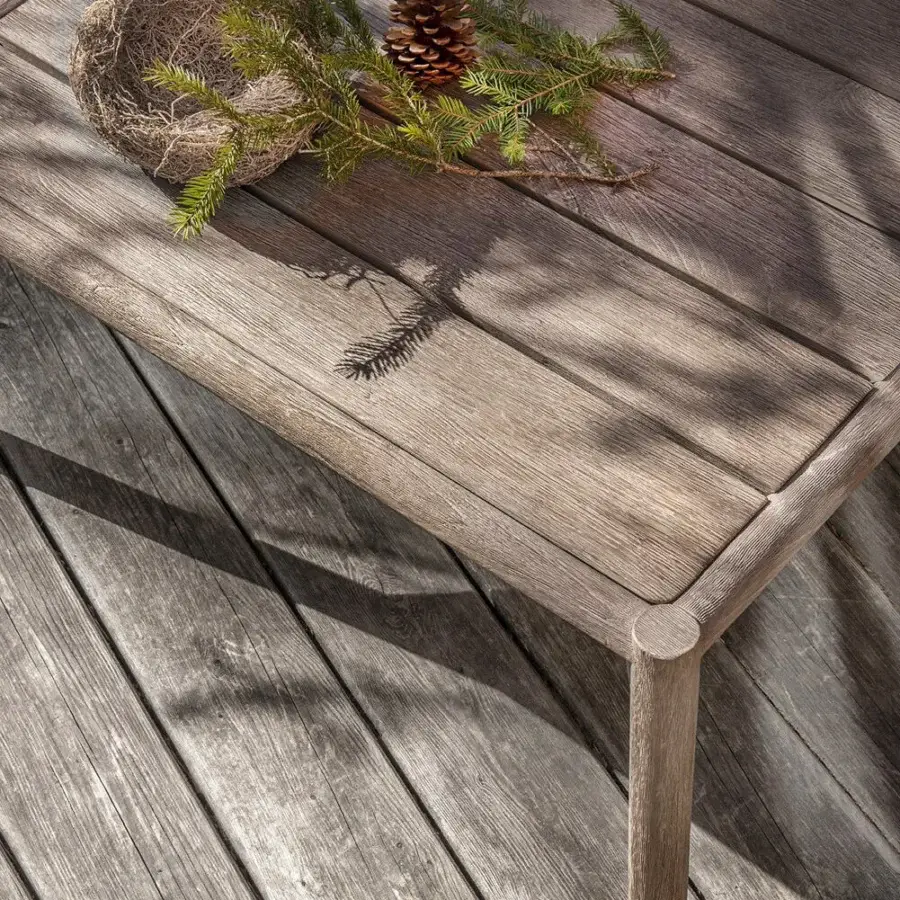 Superior Ethimo Kilt coffee table with rectangular teak tabletop and woven rope detailing in muted gray-brown tones