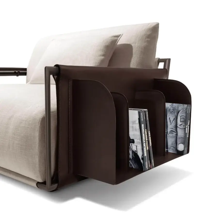 Exceptional Giorgetti Adam lounge chair with light fabric seating, pewter painted metal and brown saddle leather magazine rack