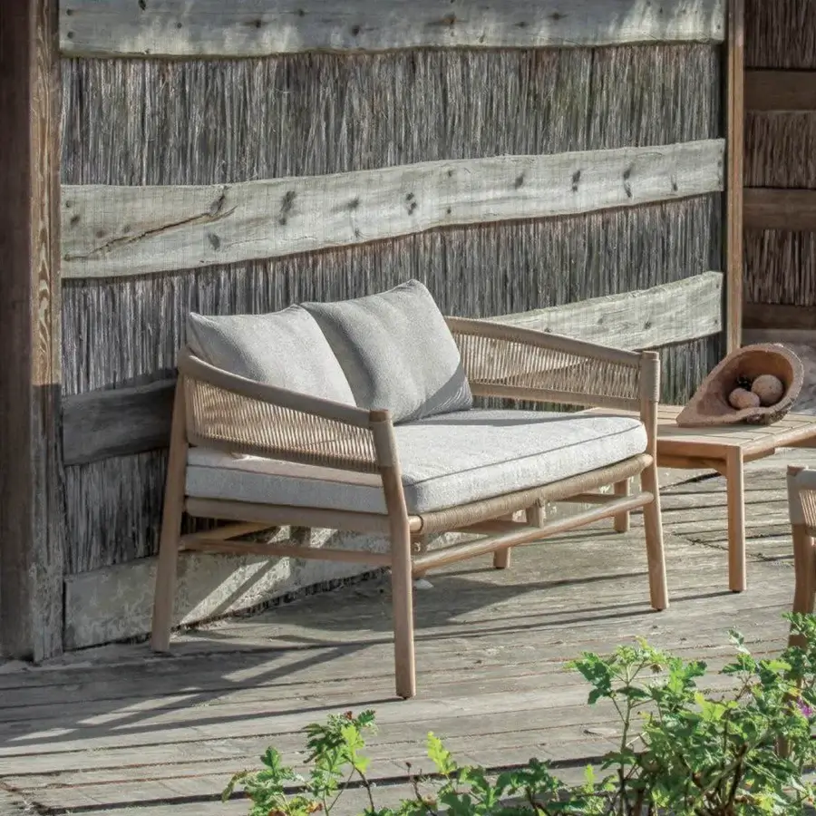 Superior Ethimo Kilt sofa crafted with FSC-certified teak and plush gray cushions in a woven natural fiber design