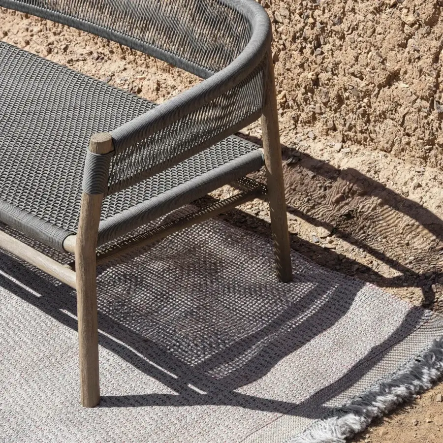 Superior Ethimo Kilt sofa with woven dark gray textile and a teak frame built for outdoor living