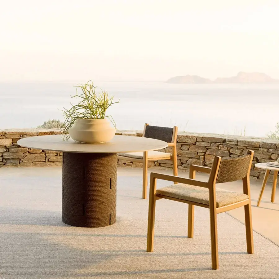 Harmonious Varaschin Gianna table with cylindrical aluminum base and bush-hammered ceramic tabletop in a light neutral tone